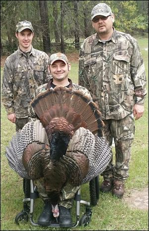 Sylvania Township native and Southview graduate Tony Nickolite, a U.S. Navy veteran who was paralyzed in an automobile accident in 2010, took part in a special wild turkey hunt on the grounds of the Toledo Airport. Guide Jim Beasley, left, and Tony's dad Ed Nickolite joined him for the hunt, one of many such hunting and fishing opportunities in the area that involve veterans.